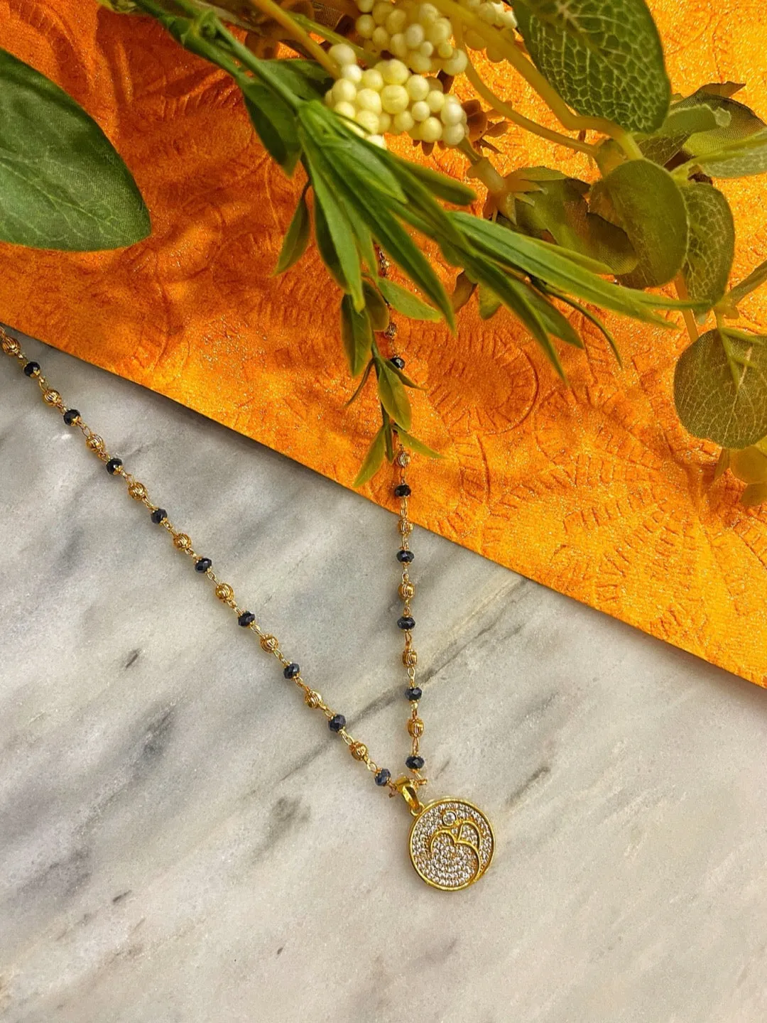 Modern Long Mangalsutra Designs American Diamond Om Pendant Crystal Gold And Black Beads Chain